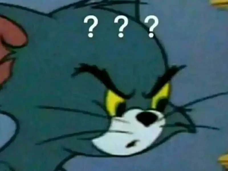 Meme mèo Tom cười với vẻ mặt lém lỉnh thú vị